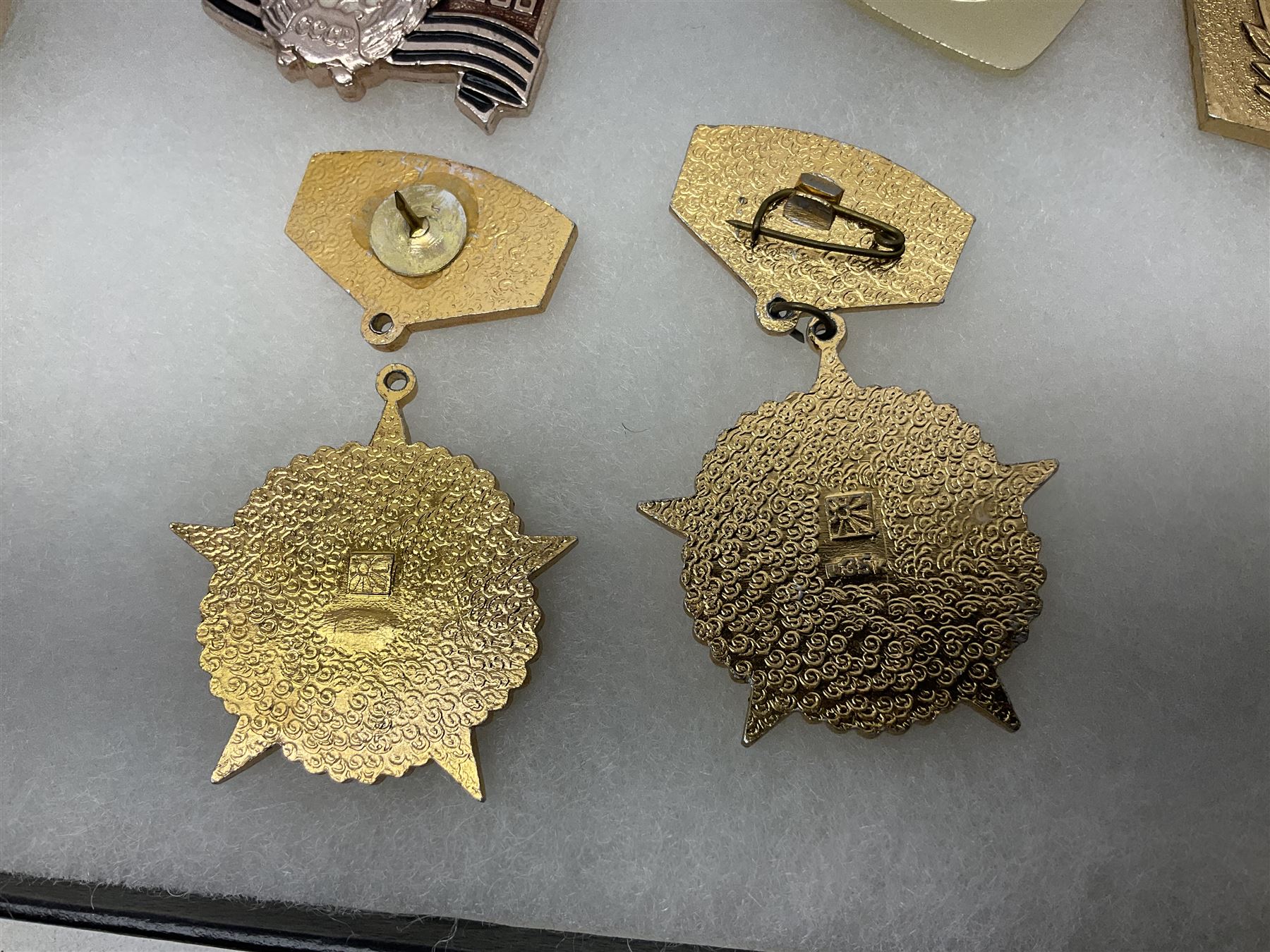Nineteen Russian Soviet Tank Commemoration badges and medals, in small display case