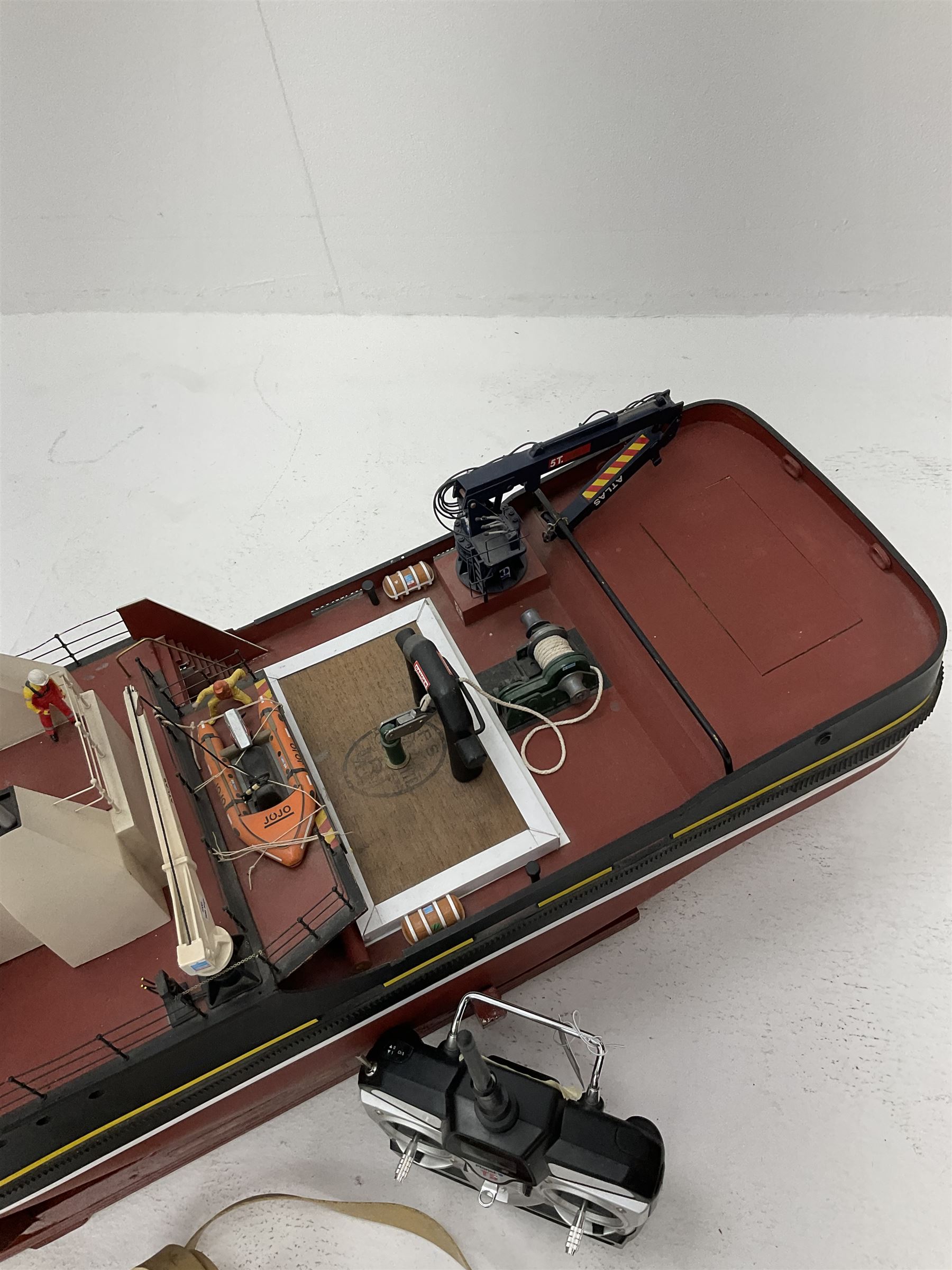 24-Volt radio controlled model of the American tug boat 'Jo-Jo' with full range of deck fittings, transmitter, remote control, receivers and two launching straps, displayed on wooden stand L103cm