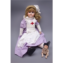  Schoenau & Hoffmeister bisque head doll with applied hair, grey sleeping eyes, open mouth with teeth, composition body with jointed limbs, purple tartan dress and red cross nurses apron, marked 'S(PB in star)H 1909 5 Germany', L60cm with German bisque baby doll (2)   