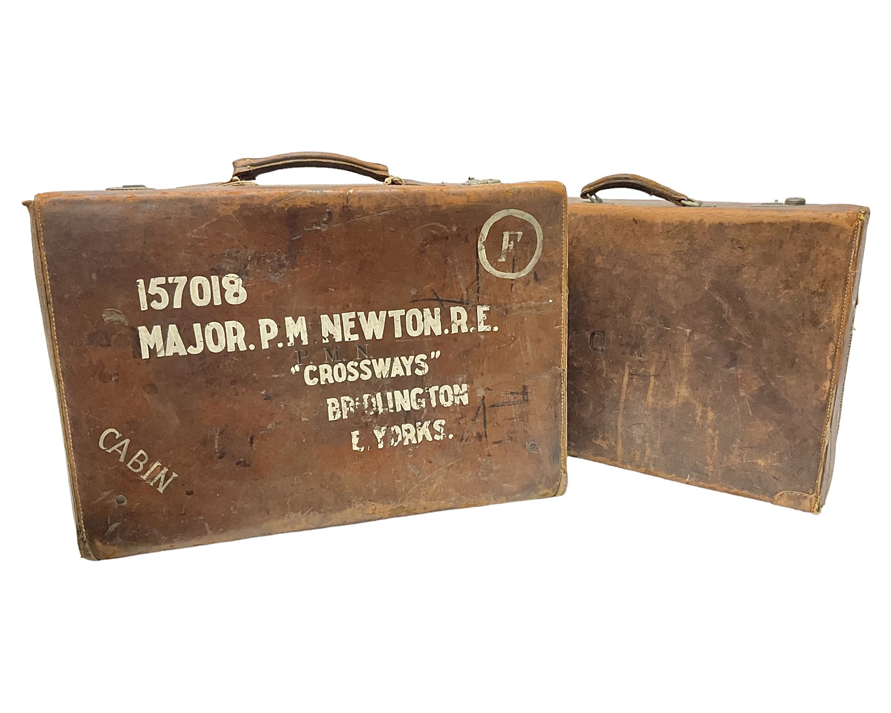 Early 20th century leather suitcase marked to the top 'Major P.M. Newton R.E. Crossways, Bridlington, East Yorkshire' 60 x 40cm; another similar leather suitcase marked W.D. to the lid; three post-WW2 respirators; and three unopened pairs of British Army N.B.C. (Nuclear Biological Chemical) No.1 Mk.III Trousers Protective (8)