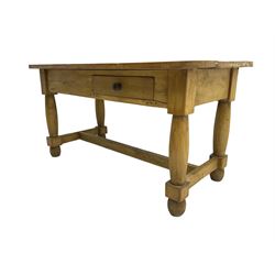 Stripped kitchen table, rectangular top with rounded edges, fitted with single drawer, raised on shaped supports united by stretcher