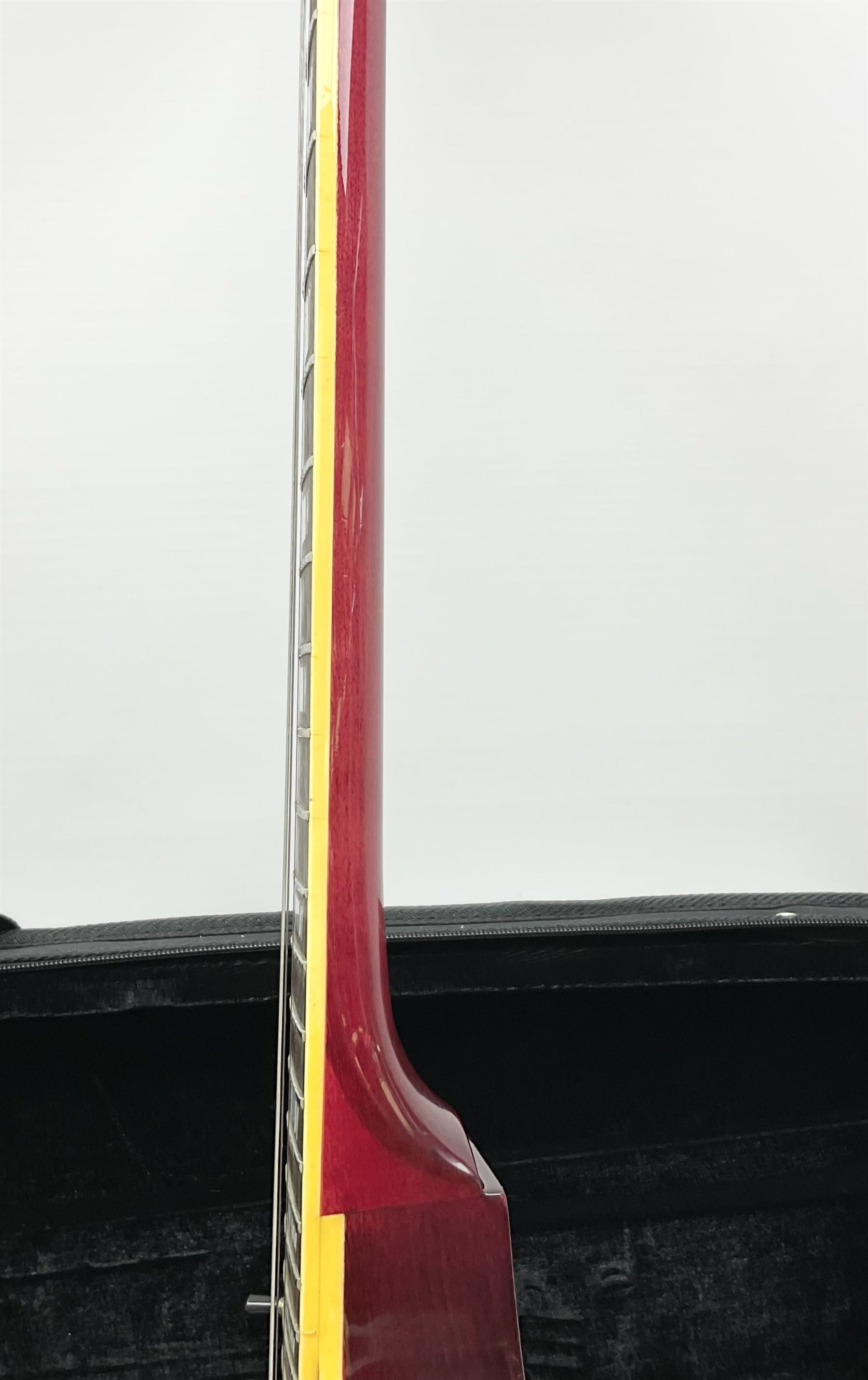 1980s Les Paul Epiphone limited edition cut-away electric guitar by Gibson, the burgundy coloured body with two pick-ups, volume and tone knobs and scratch plate, original tuning pegs, serial no.U6030215, 101cm overall; in modern Kinsman fitted carrying case