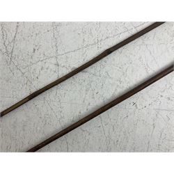 Native long-shafted spear, the large iron head with central medial ridge and decorative neck, on plain circular haft L260cm; and another similar Native long-shafted spear with cane haft L249cm (2)