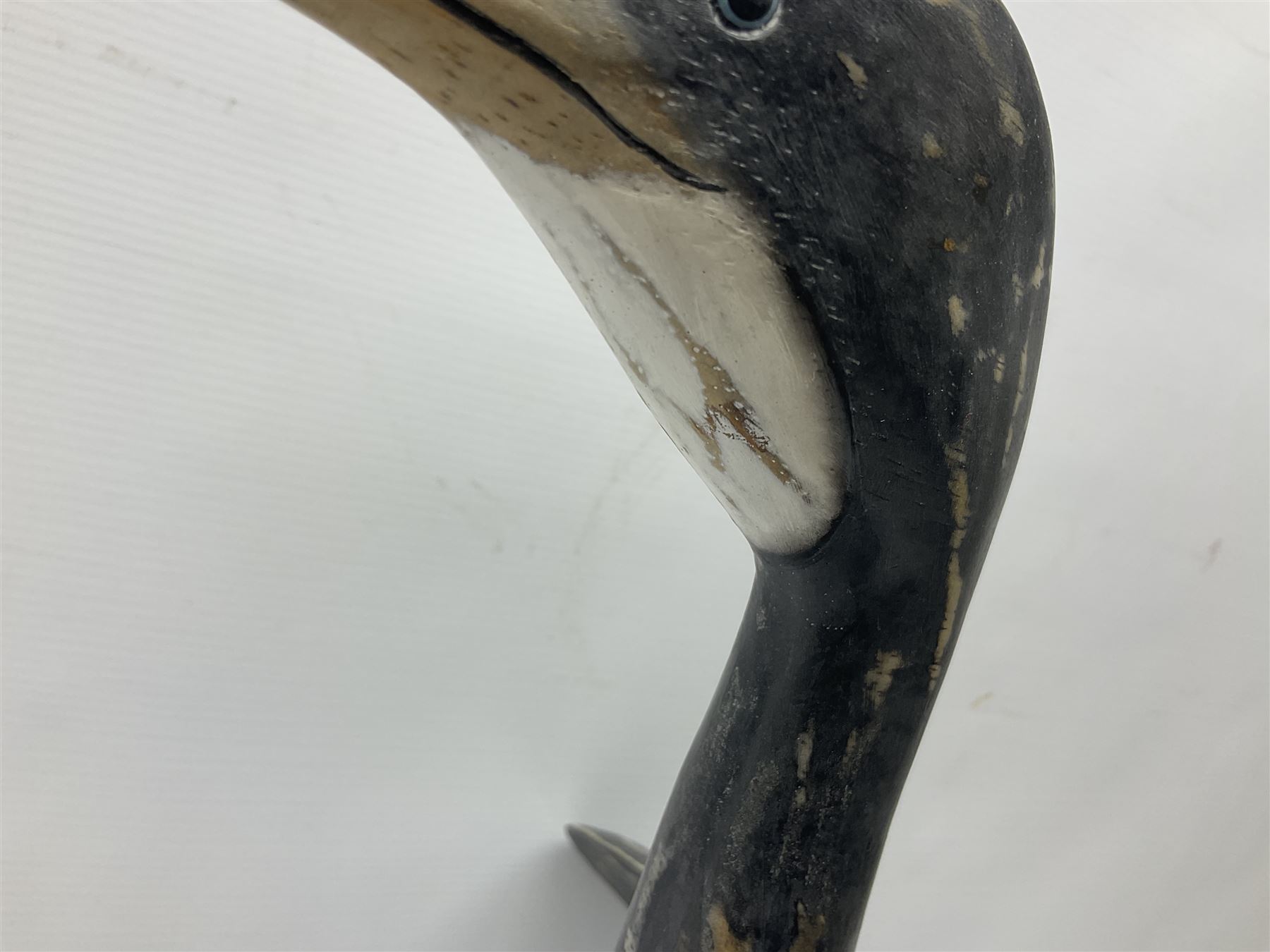 Wooden sculpture of Cormorant aquatic bird on a naturalistic wooden plinth, H46cm