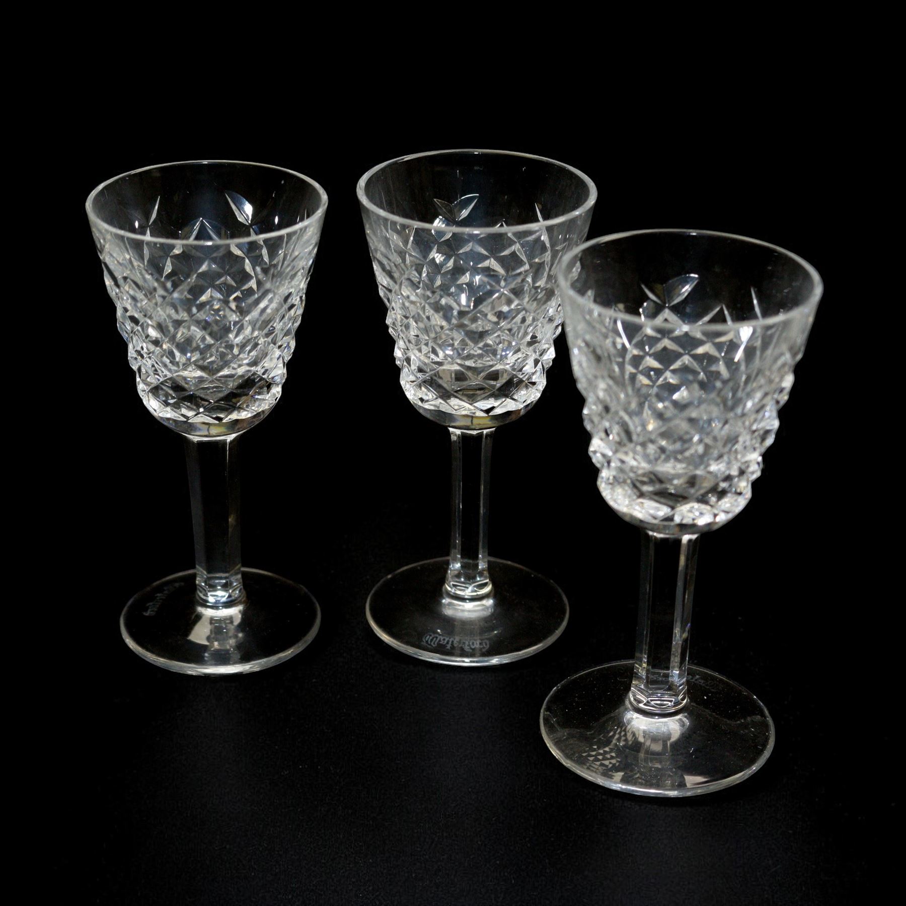 Waterford crystal Alana pattern glassware, comprising water jug, two tall tumblers, six port glasses and six sherry glasses, together with a single candle holder, jug H17cm