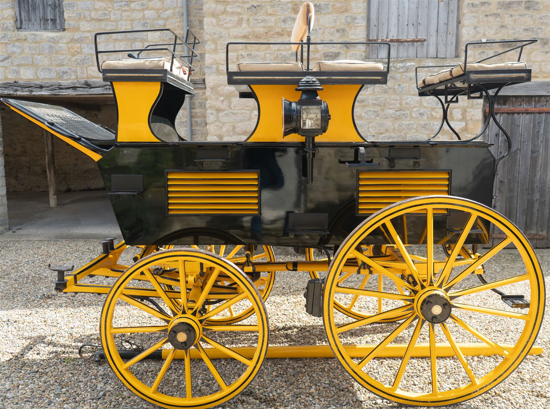 Roof Seat Break by Shanks of London

A roof seat break by Shanks of London built on a perch in black and yellow livery, the body fitted with an elevated driver's box seat, elevated rear groom's seat and central passenger compartment. The carriage is mounted on wooden spoked wheels with leaf spring suspension and is equipped with louvred underbody storage compartments, carriage lamp brackets (lamps next lot), folding access steps and a pole for driving with a pair or team of horses. The wheel hubs are stamped 