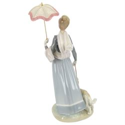 Lladro figure, Lady with Shawl, modeled as a woman holding a parasol with an afghan hound, model no 4914, H46cm 