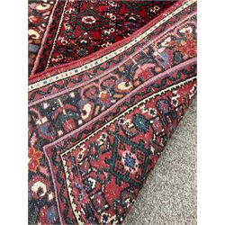 Persian red ground runner, decorated with repeating Heratti motifs, stylised floral guarded border
