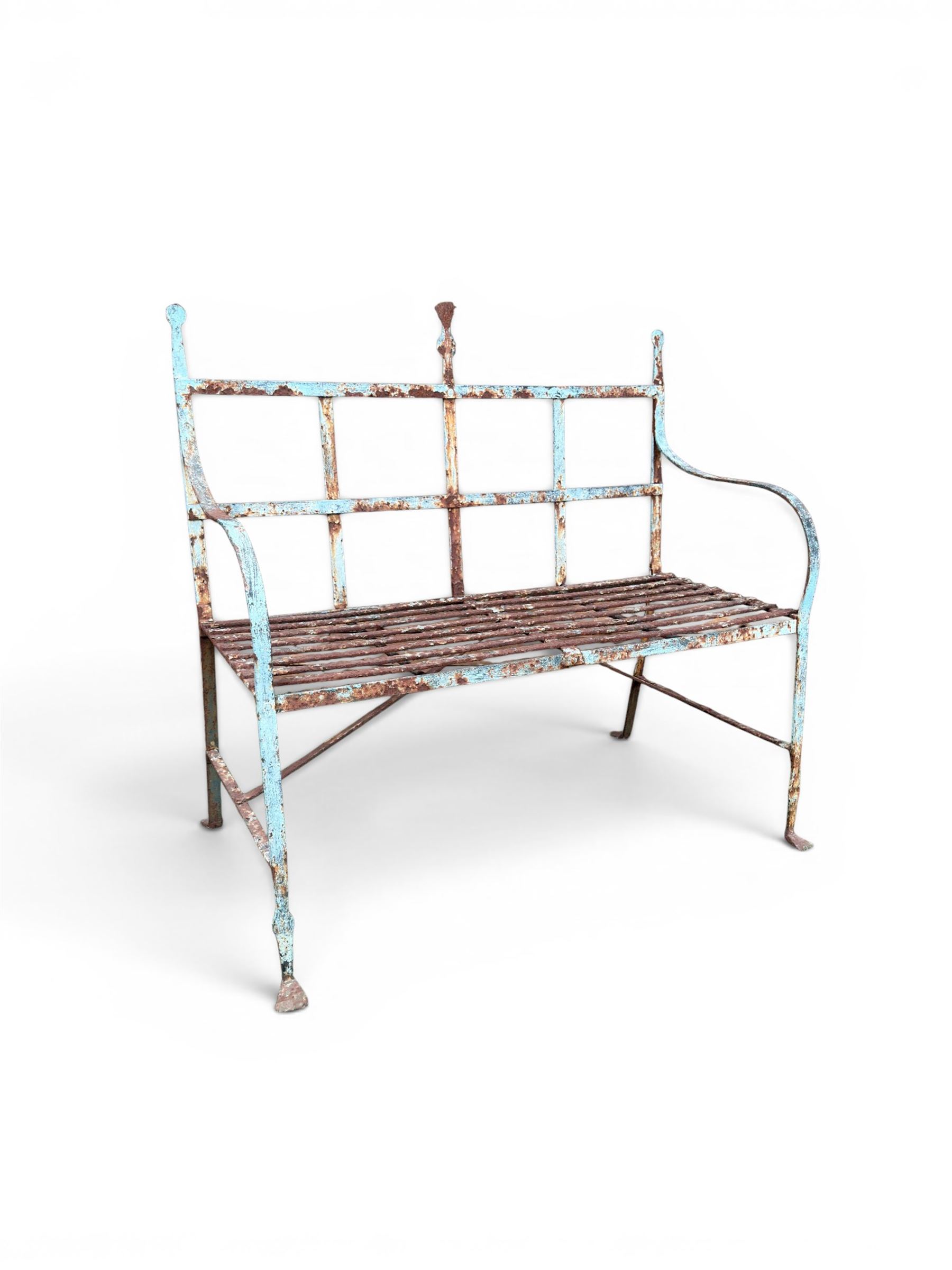 Regency period wrought iron strapwork garden bench, cresting rail with central Scottish thistle motif and flanking pediments, in distressed blue painted finish