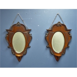  Pair late 19th century walnut cartouche shaped wall mirrors with bracket and bevelled edged oval plates, H55cm x W36cm   