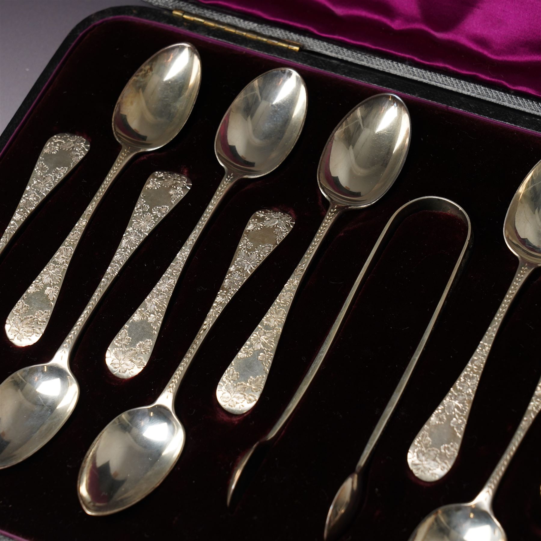Cased set of twelve Victorian silver tea spoons and tongs with floral engraved stems London 1894 Maker Wakely & Wheeler
