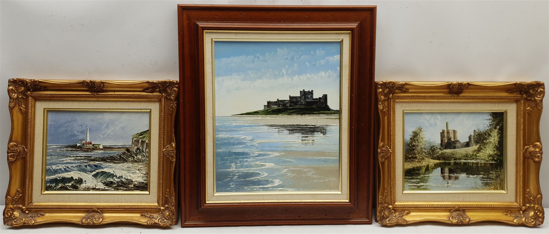 Dallas K Taylor (British 1941-2011): 'Reflections of Bamburgh' 'St Mary's Island' and 'Warkworth Castle', three oils on board signed titled and dated verso 35cm x 29cm and 19cm x 24cm (3)