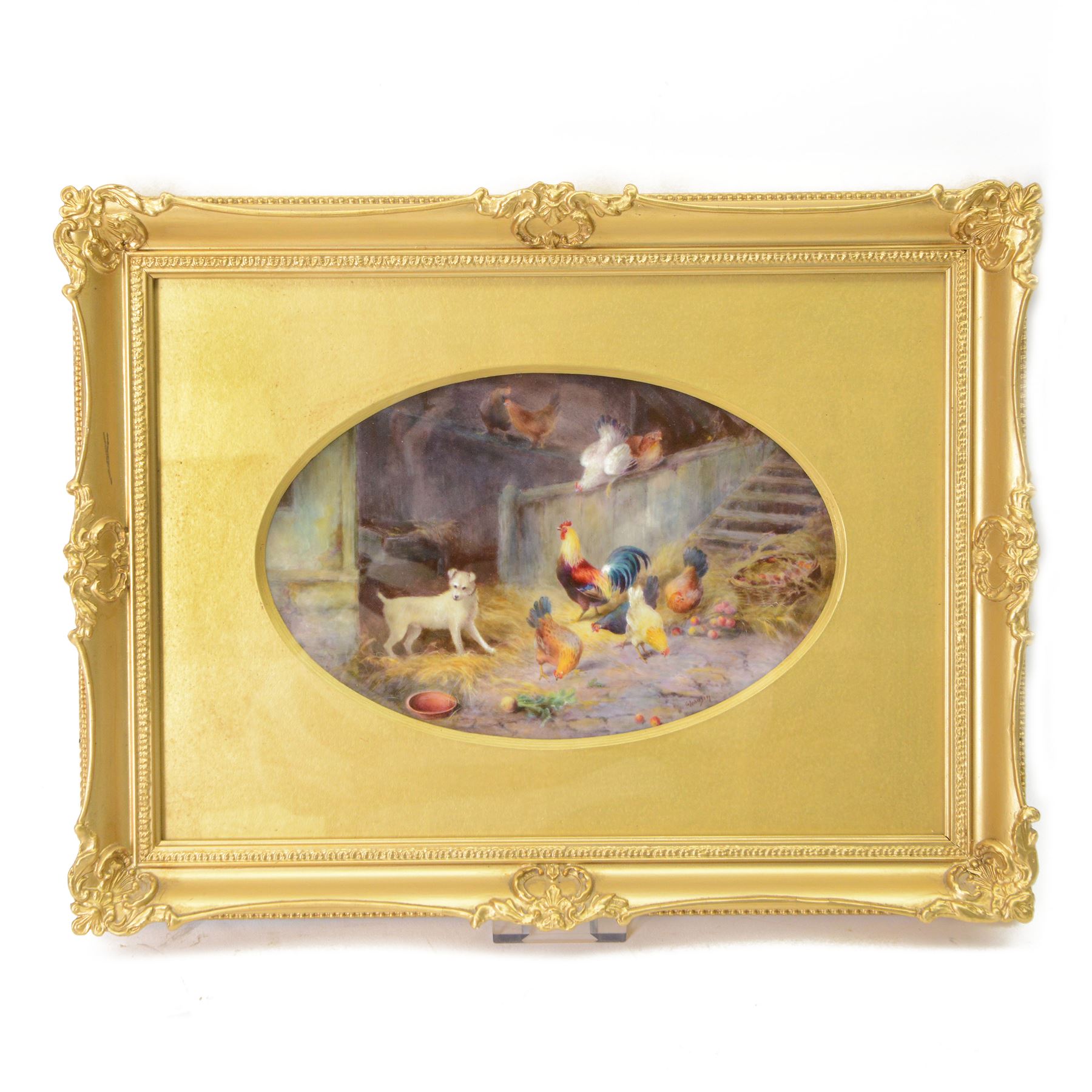 Early 20th century Royal Worcester oval plaque, hand painted by George Johnson, depicting a farmyard scene with white terrier dog, cockerel and chickens within a barn, signed G Johnson, with puce printed mark verso, date code indistinct, circa 1925, plaque 15cm x 23.5cm, overall 30cm x 39cm