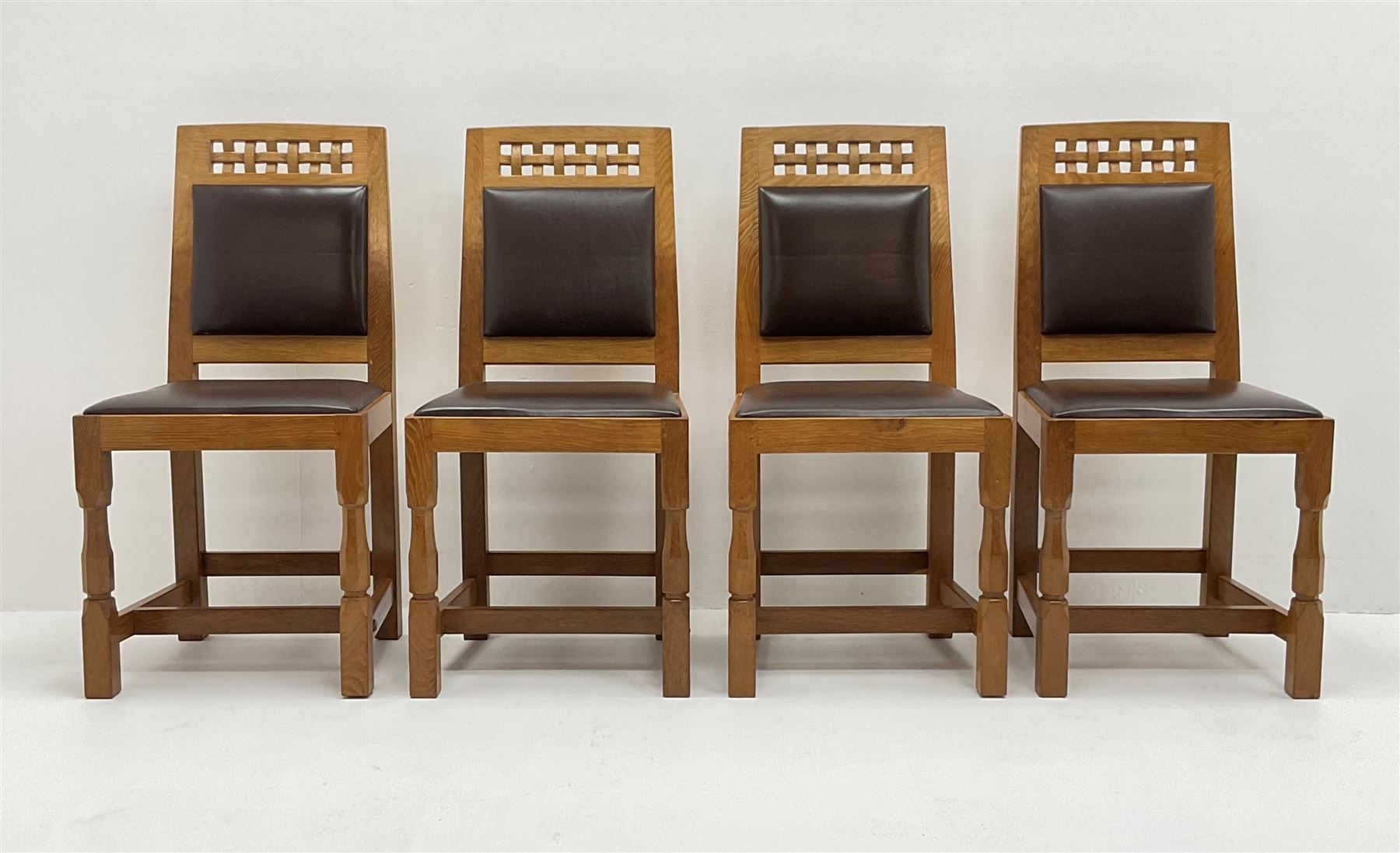 'Lizardman' set six dining chairs, two carvers and four side chairs, carved and pierced lattice top rail over cushioned back and drop in seat upholstered in brown leather, by Derek Slater of Crayke
