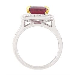 18ct white gold rubellite tourmaline and diamond cluster ring, single octagonal cut tourmaline of 4.05 carat, four claw set in yellow gold, surrounded by  round brilliant cut diamonds, with split diamond set shoulders, London 2013, total diamond weight 1.24 carat