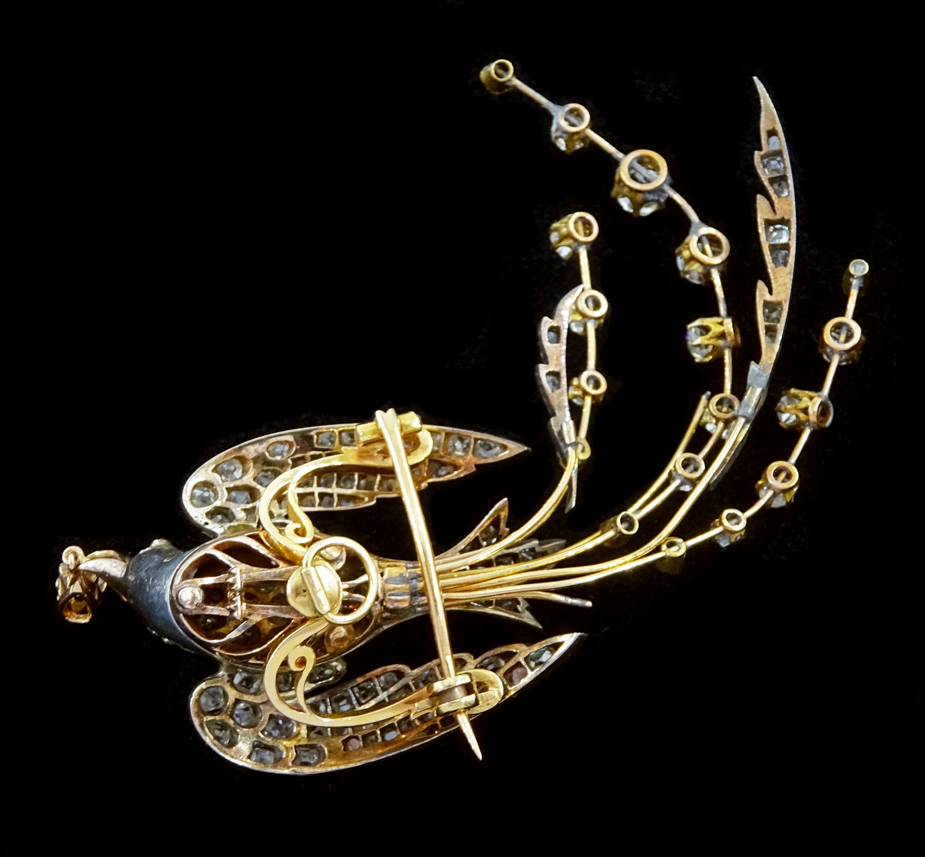 Victorian diamond swallow aigrette brooch, the gold backed silver swallow in flight set with old cut and rose cut diamonds, with cabochon ruby eyes, holding a pear cut diamond of approx 0.25 carat, to an old cut diamond spray tail of approx 1.95 carat, total diamond weight approx 4.00 carat