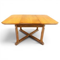 Waring & Gillow - Arts and Crafts oak draw-leaf extending dining table rectangular moulded top with chamfered corners, two additional leaves, carved frieze over fluted section supports, united by low X-shape stretchers