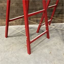 Pair of vintage red painted A frame trestles, with original A W Oates Painter signage