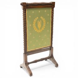 Victorian mahogany firescreen, the rectangular upholstered panel decorated with a Greek urn within laurel wreath on green ground, within spiral turned uprights, on downswept supports united by a turned stretcher