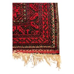 Turkoman red ground wool rug, the field with a repeating pattern of Tekke gul motifs in dark brown and red (195cm x 98cm); Afghan Bokhara red ground wool rug, central field with repeated geometric octagonal gul motifs, surrounded by multiple borders with stylised diamond and triangular patterns (127cm x 181cm)