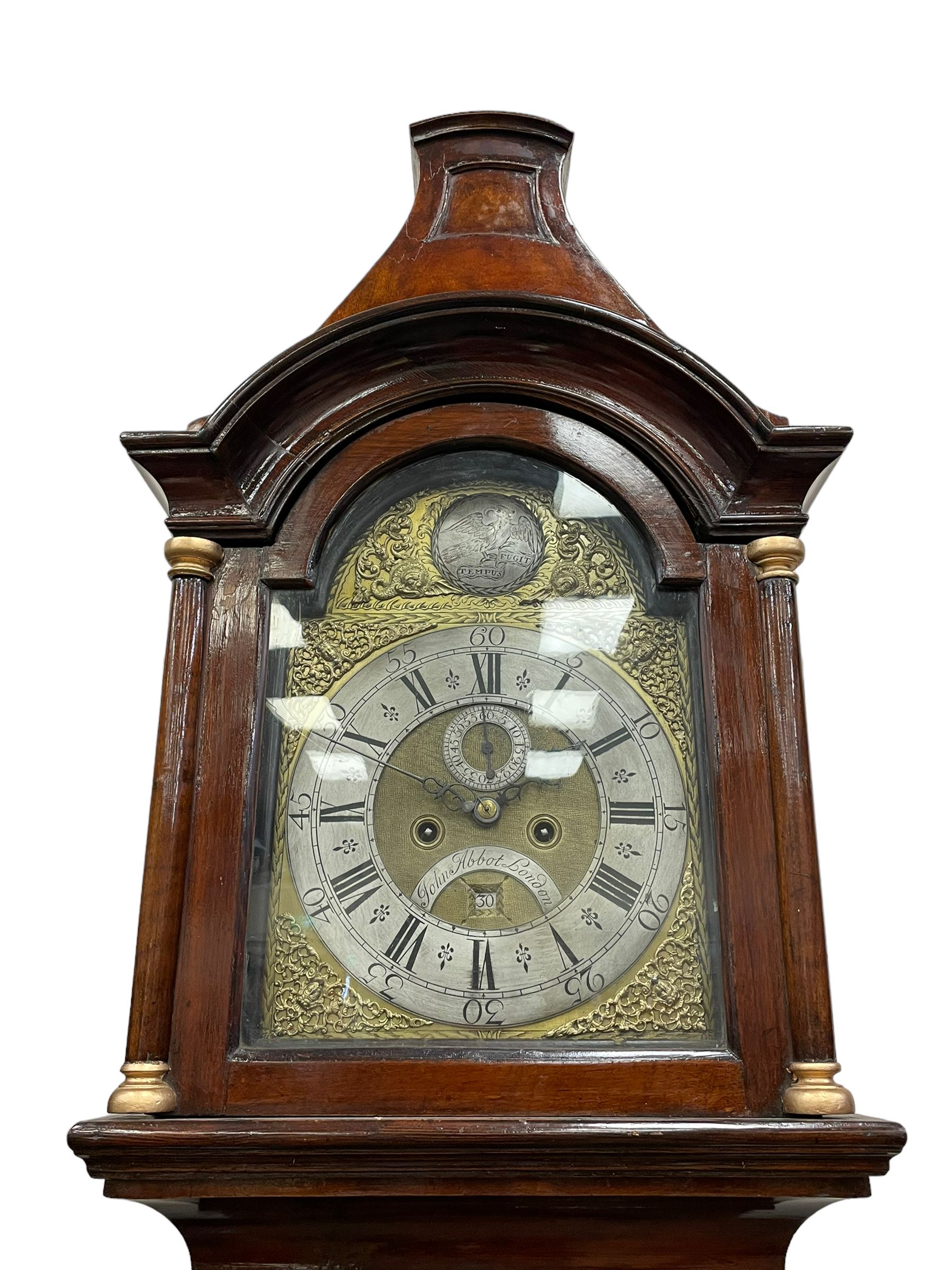 John Abbot of London – early 18th century walnut 8-day longcase clock c1740, hood with glazed side panels and tall swept pagoda pediment above a break arch hood door with attached pillars and gesso wooden capitals, long trunk door with a conforming break arch top on a rectangular plinth with applied shaped skirting, brass dial with a matted center and continuous herringbone engraving to the surround, cast spandrels, silvered chapter with Roman numerals, five minute Arabic’s, minute track and inner quarter hour track, subsidiary seconds dial and square date aperture, silvered tempus fugit boss to the break arch, dial pinned directly to a rack striking movement, striking the hours on a bell. With weights and pendulum.