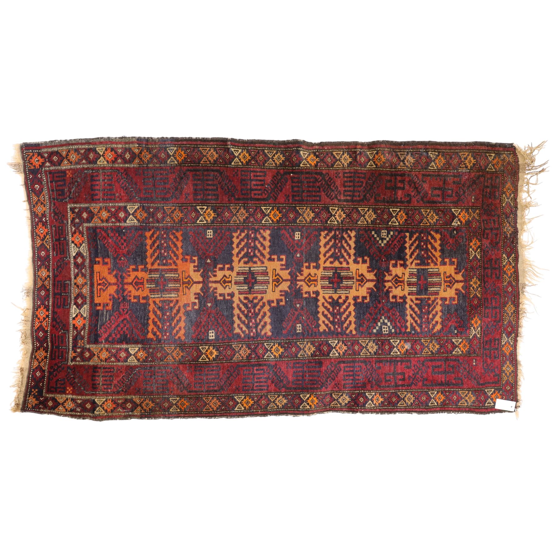 Baluch hand-knotted rug, deep red and indigo field decorated with a vertical arrangement of stylized geometric medallions within multiple narrow borders, 95x163cm, and Tekke Turkman rug, madder red field decorated with repeating rows of octagonal guls, framed by multiple geometric borders 84x129cm, (2)