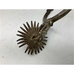 Pair of late 19th century South American iron spurs, engraved silver mounts, with sunburst rowls