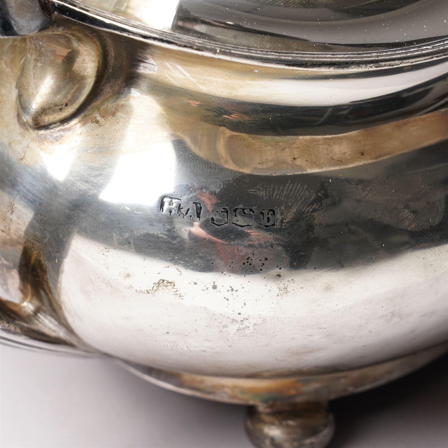 Silver tea pot of oval form with ebonised handle and lift on compressed bun feet Sheffield 1919 Maker Atkin Bros.