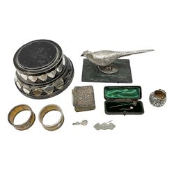 Group of silver, to include filled figure of a pheasant, hallmarked for London, pair of silver mounted horn napkin rings, miniature Edwardian bible with silver cover embossed with putti, Victorian silver brooch, ebonised plinth with applied inscribed silver shields, etc., together with two stick pins, one example with 9ct gold terminal 