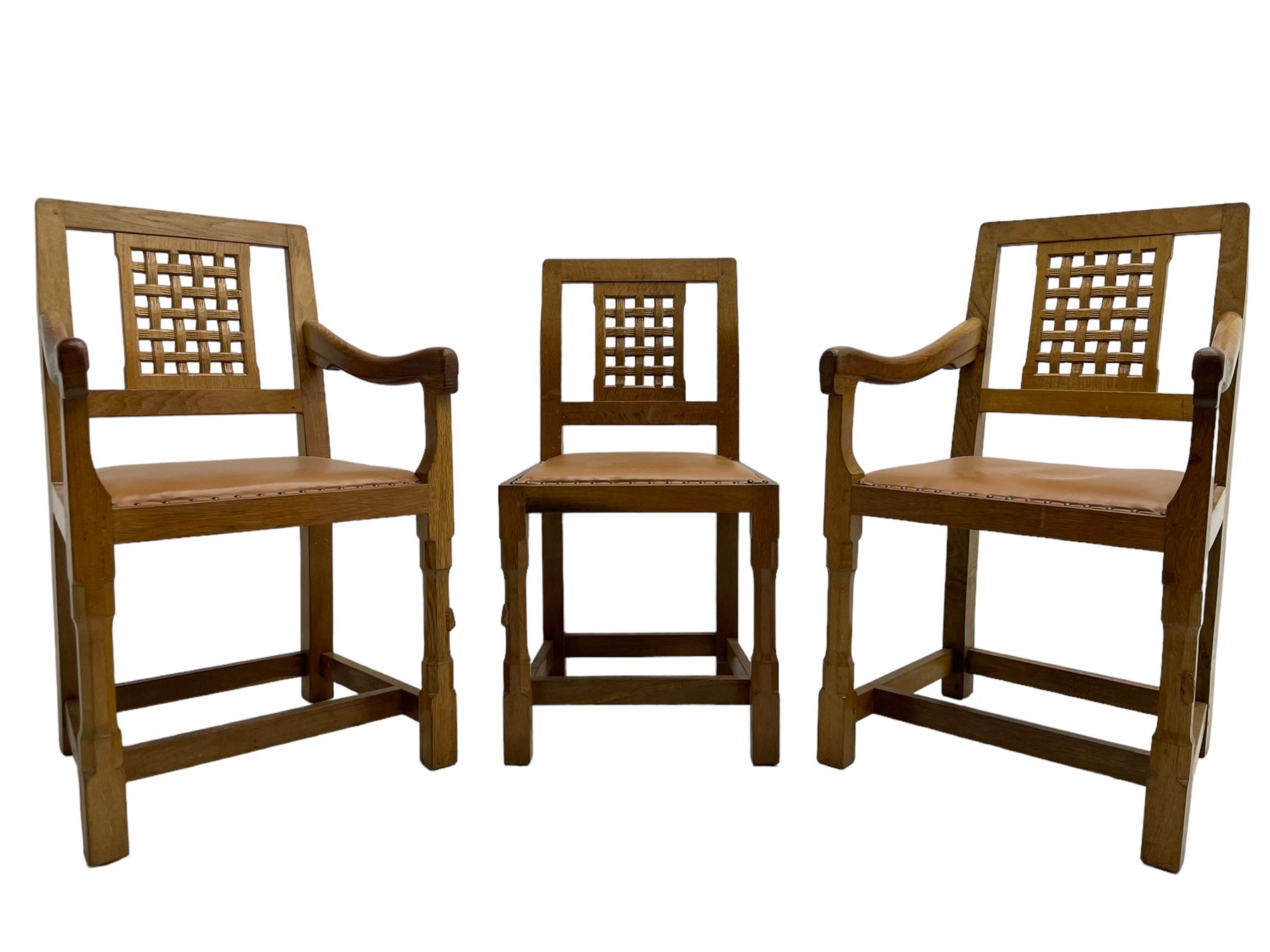 Rabbitman - set of six (4+2) oak dining chairs, carved and pierced lattice back, tan leather upholstered seat with stud band, on octagonal supports united by H-stretchers, carved with rabbit signature, by Peter Heap, Wetwang 