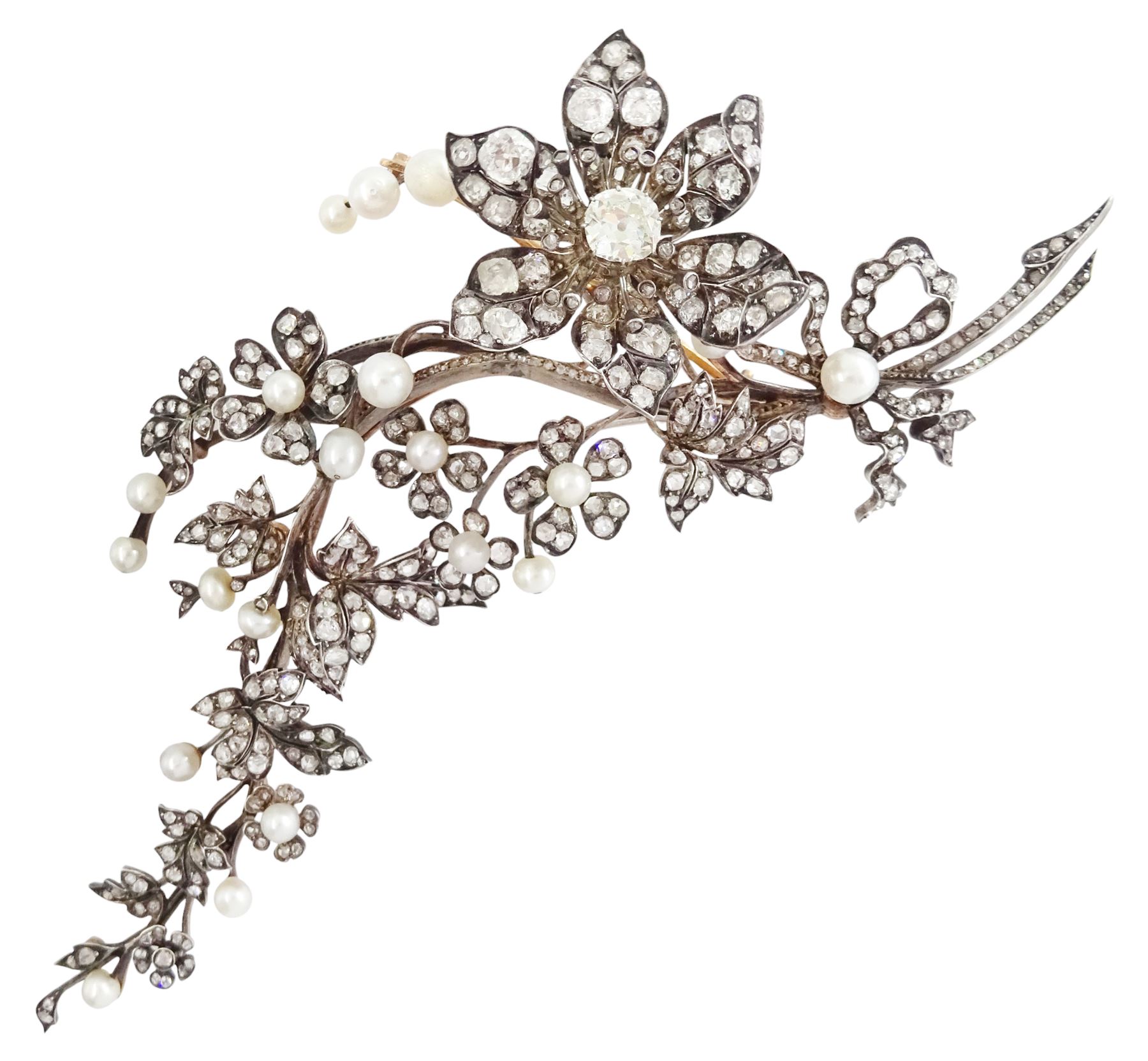 19th century gold and silver diamond and pearl en tremblant detachable brooch, the flower tremblant with a principal old cut diamond of approx 1.90 carat, the petals and stamen set with old cut and rose cut diamonds, total diamond weight approx 9.10 carat, to a foliate spray set set with further rose cut diamond and white / pink / cream pearls and ribbon tie