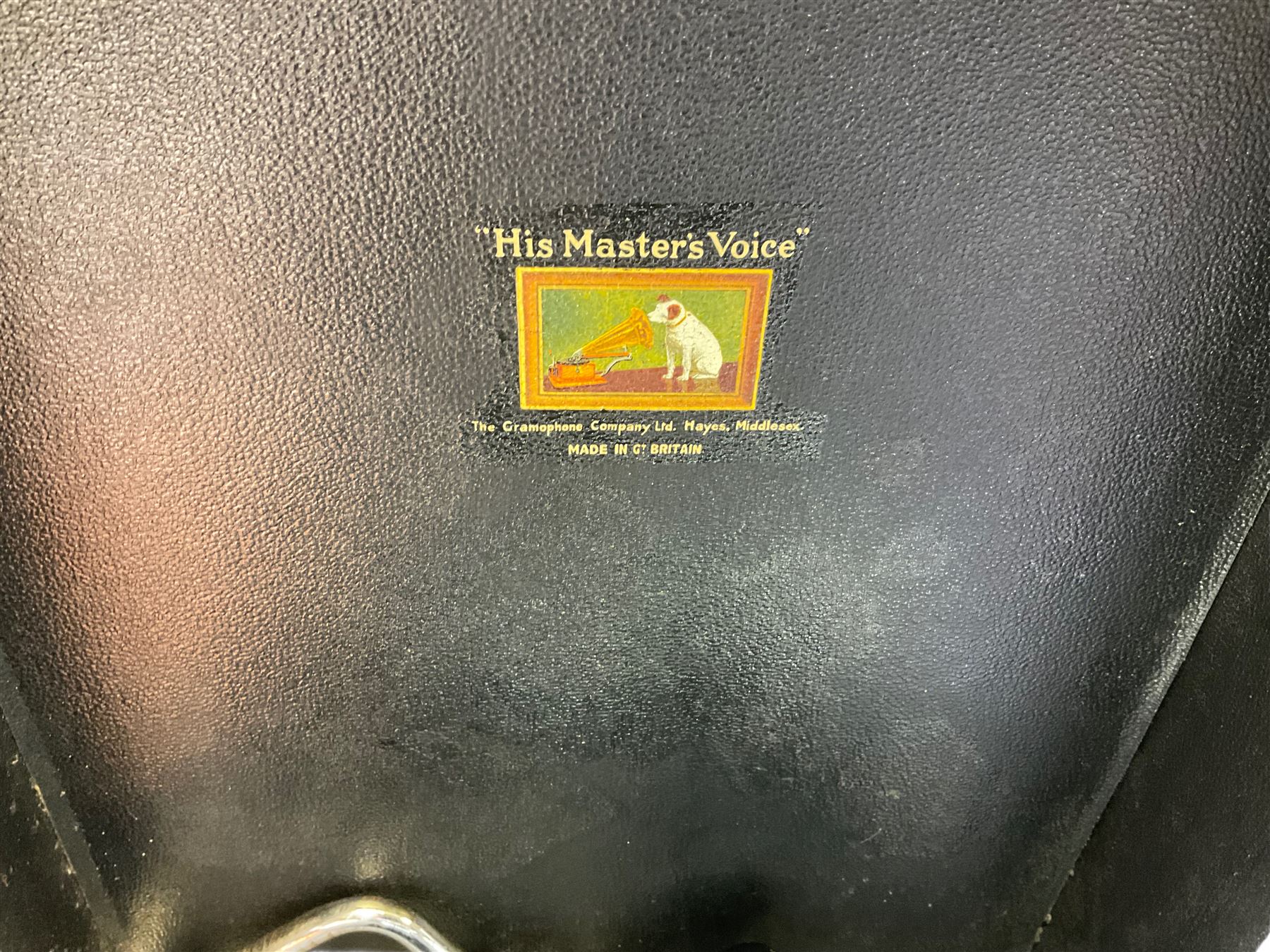 HMV portable wind up gramophone in a black case, together with a collection of records. 