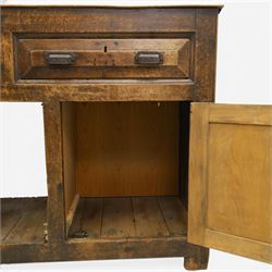 18th century rustic oak dresser base, with fielded panels and iron cup handles with embossed greek key and foliate detail, three short drawers above and open recess flanked by two cupboard doors, raised on stile supports