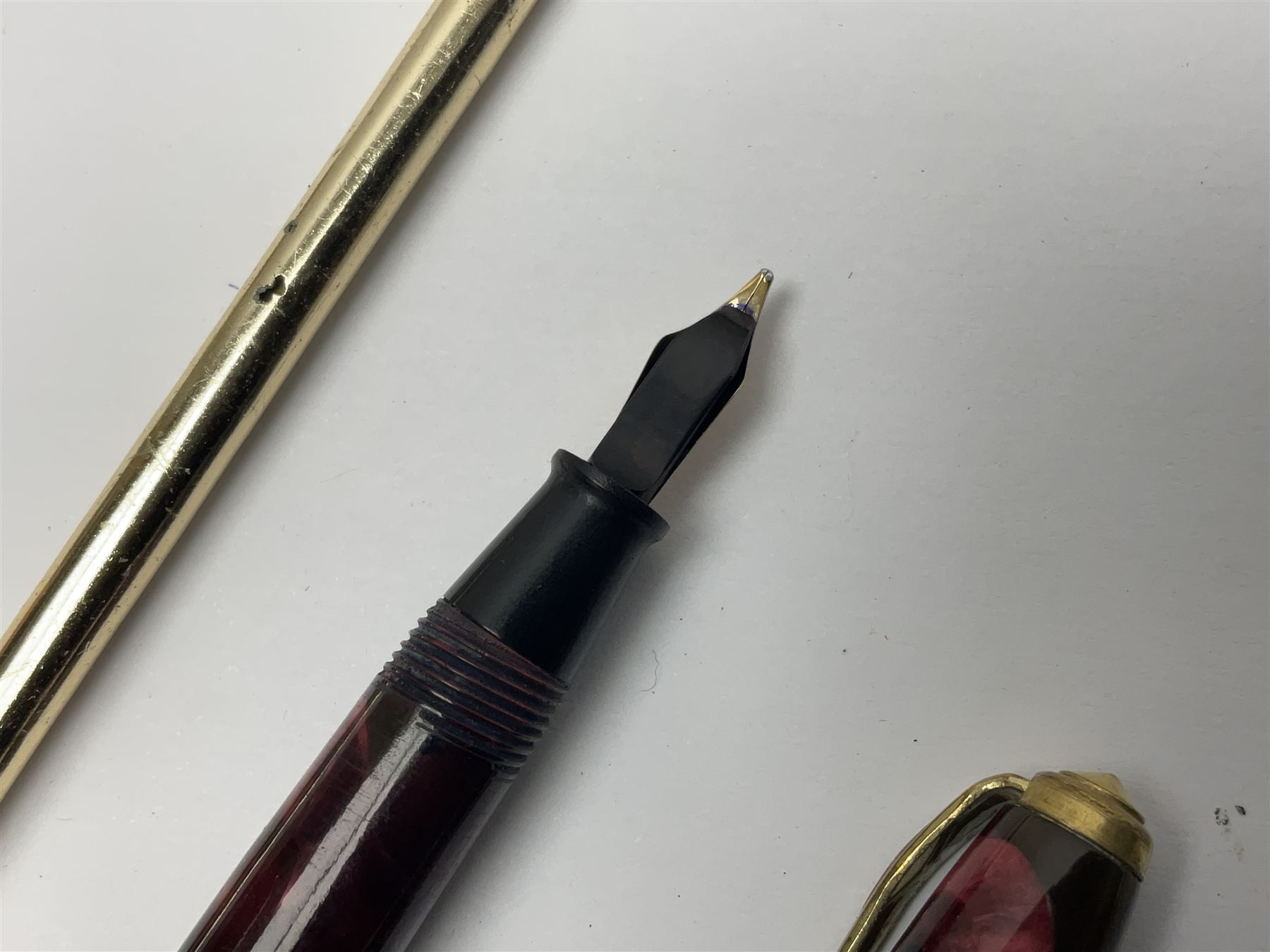 Three fountain pens, to include Conway Stewart 'Dinkie 550' and 'Conway 57' and a Parker 'Slimfold', all with 14ct gold nibs, together two roller ball pens, including a Parker example and a Swarovski Crystal paperweight