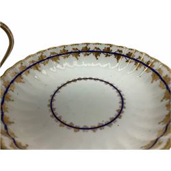 Early 19th century Derby teacup and saucer, circa 1806-1825, of fluted form, each painted with blue bands and gilt foliate tendril bands, with red painted mark beneath, teacup H7cm saucer D13.5cm
