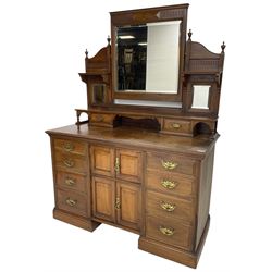 Edwardian mahogany dressing chest, raised triple mirror back with bevelled plates and fluted decoration over two trinket drawers, the base fitted with two central cupboards flanked by four graduating drawers to each side