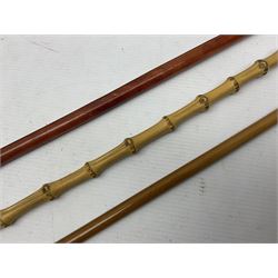 Three swagger sticks - leather covered with spherical terminal embossed with Oman Muscat emblem L68cm; cane carved NAN, the metal terminal with RFC emblem; and malacca cane with spherical terminal embossed with regimental garter crest (3)