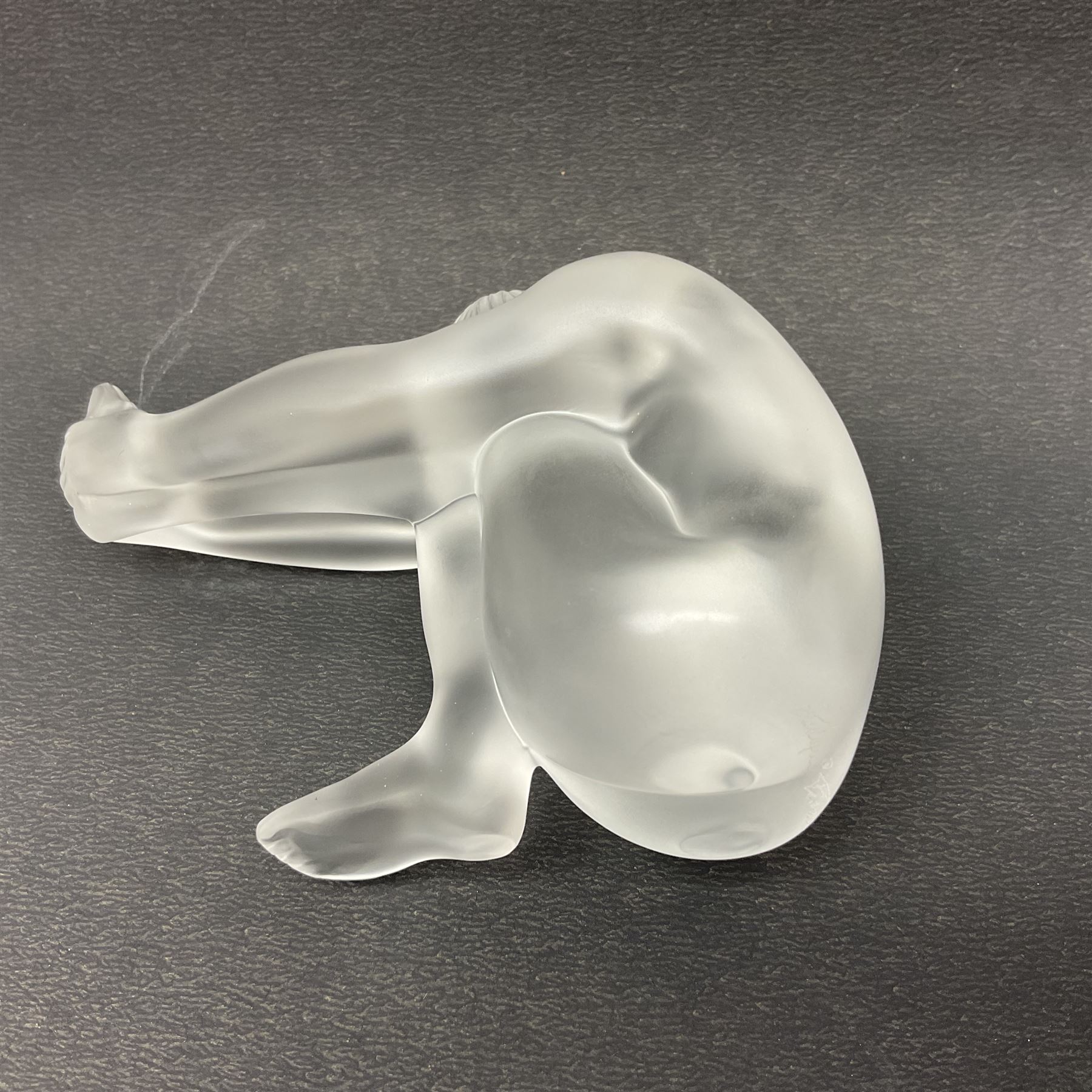 Lalique Nude Temptation, a frosted glass figure of a woman crouching with leg outstretched, in original box, H8cm