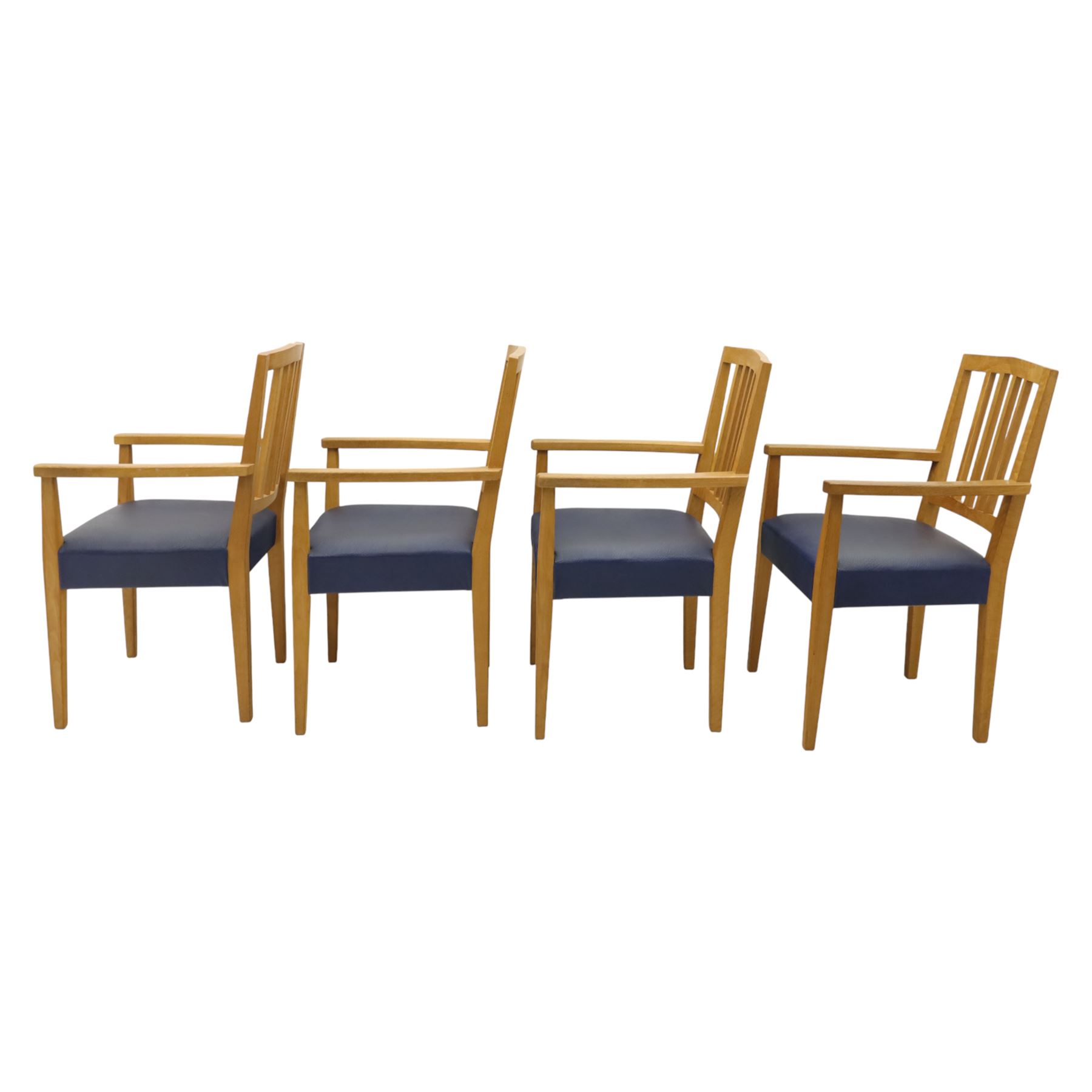 Modern twelve oak dining chairs including one 'Chairmans' chair, solid oak construction, slatted back and arm rests, blue leatherette padded seat, on tapered square supports 