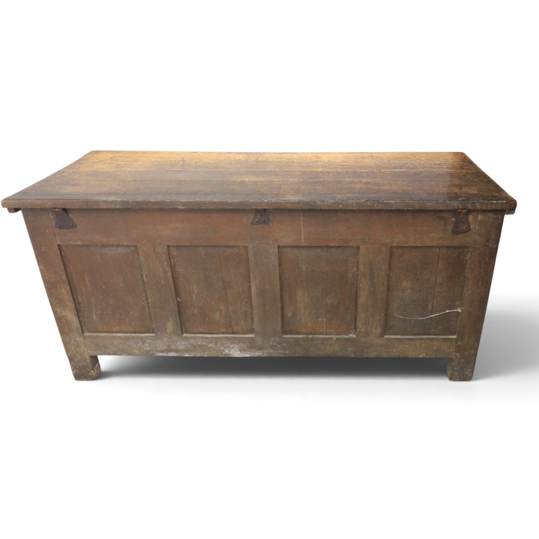 Large 17th century oak coffer, plank top with moulded edge, four panel front with channel moulded uprights, retaining original wrought iron strap hinges and central lock plate, panelled ends, raised on stile supports