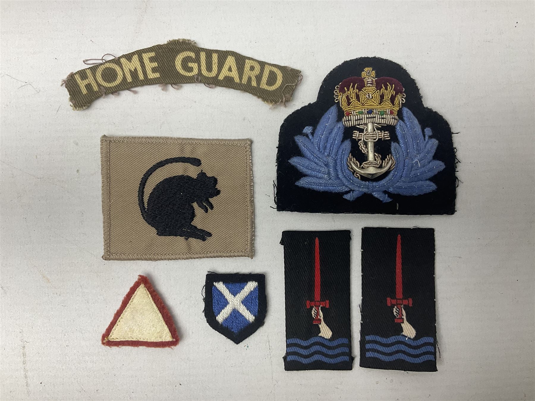 Royal Arms cloth arm adge as worn by Regimental Serjeant-Majors in Foot Guards; naval cap badge; WW2 Commando/Special Forces cloth badges; Home Guard and LDV shoulder titles; and other cloth badges including armoured division, 45th and 77th division, 52nd Lowland Mountain division etc; and 24th Infantry Brigade airmobile pennant