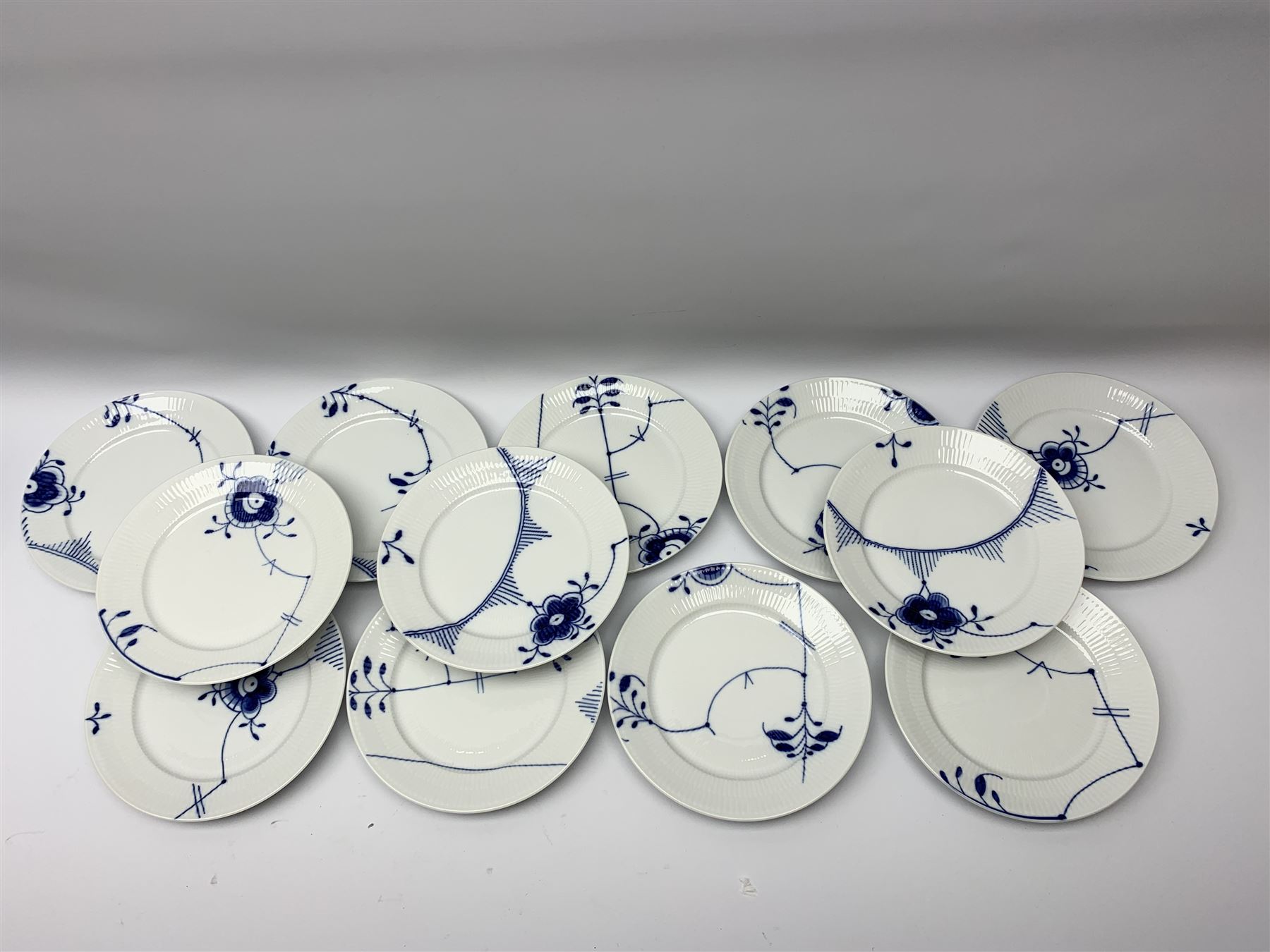 Royal Copenhagen tea and dinner service for twelve place settings, decorated in the Mega Blue Fluted pattern, pattern number 622, comprising dinner plates, salad plates, bowls with pierced rim, smaller bowls, tea cups, and saucers, dinner plates D27.5cm, salad plates D22cm