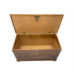 Hong Kong camphor wood chest, rectangular hinged top, carved all over with traditional scenes and dragon boats, on bun feet