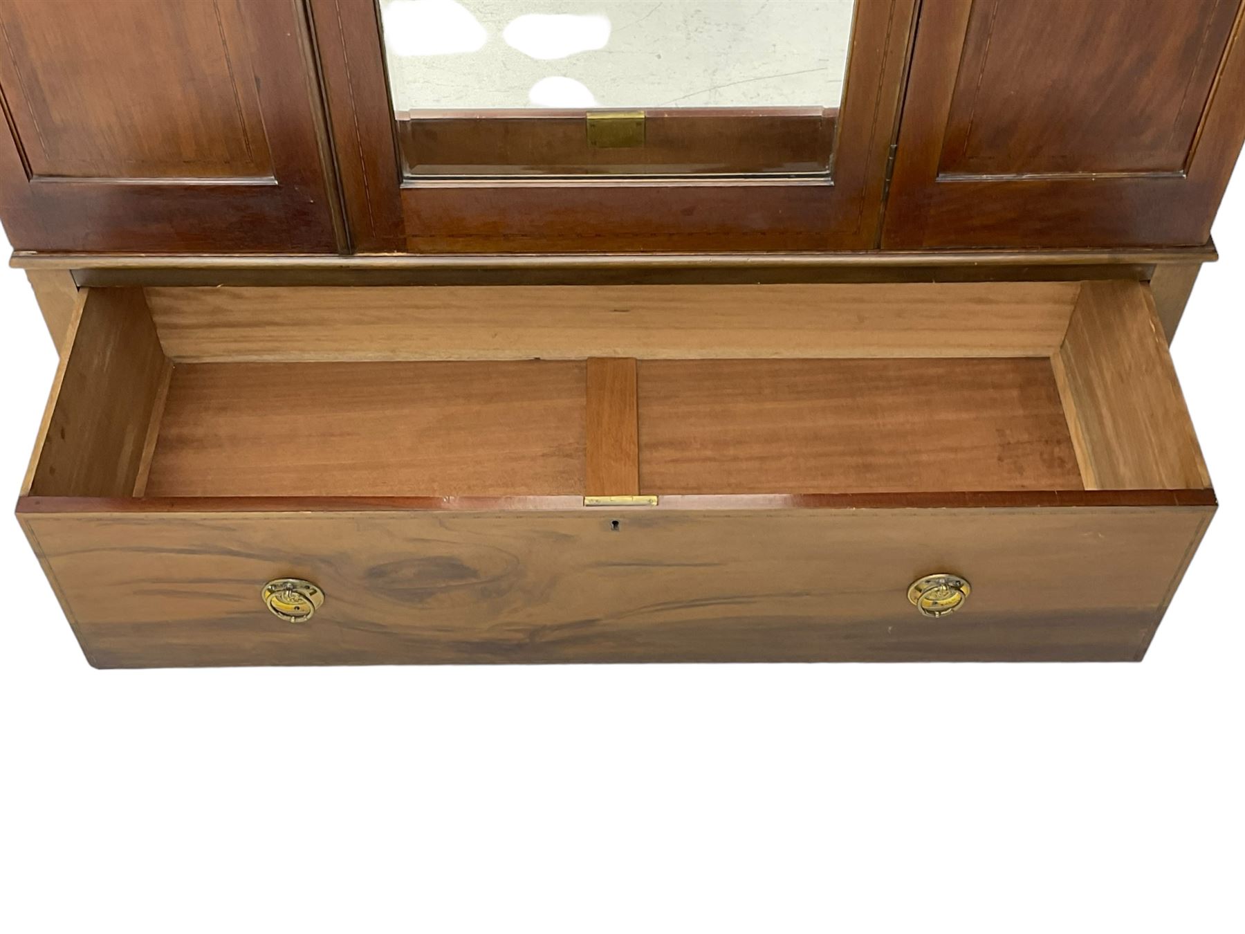 Edwardian inlaid mahogany wardrobe, projecting moulded cornice over central bevelled mirror glazed door, panelled uprights inlaid with trailing bellflowers and foliate decoration, the skirted base fitted with single drawer 