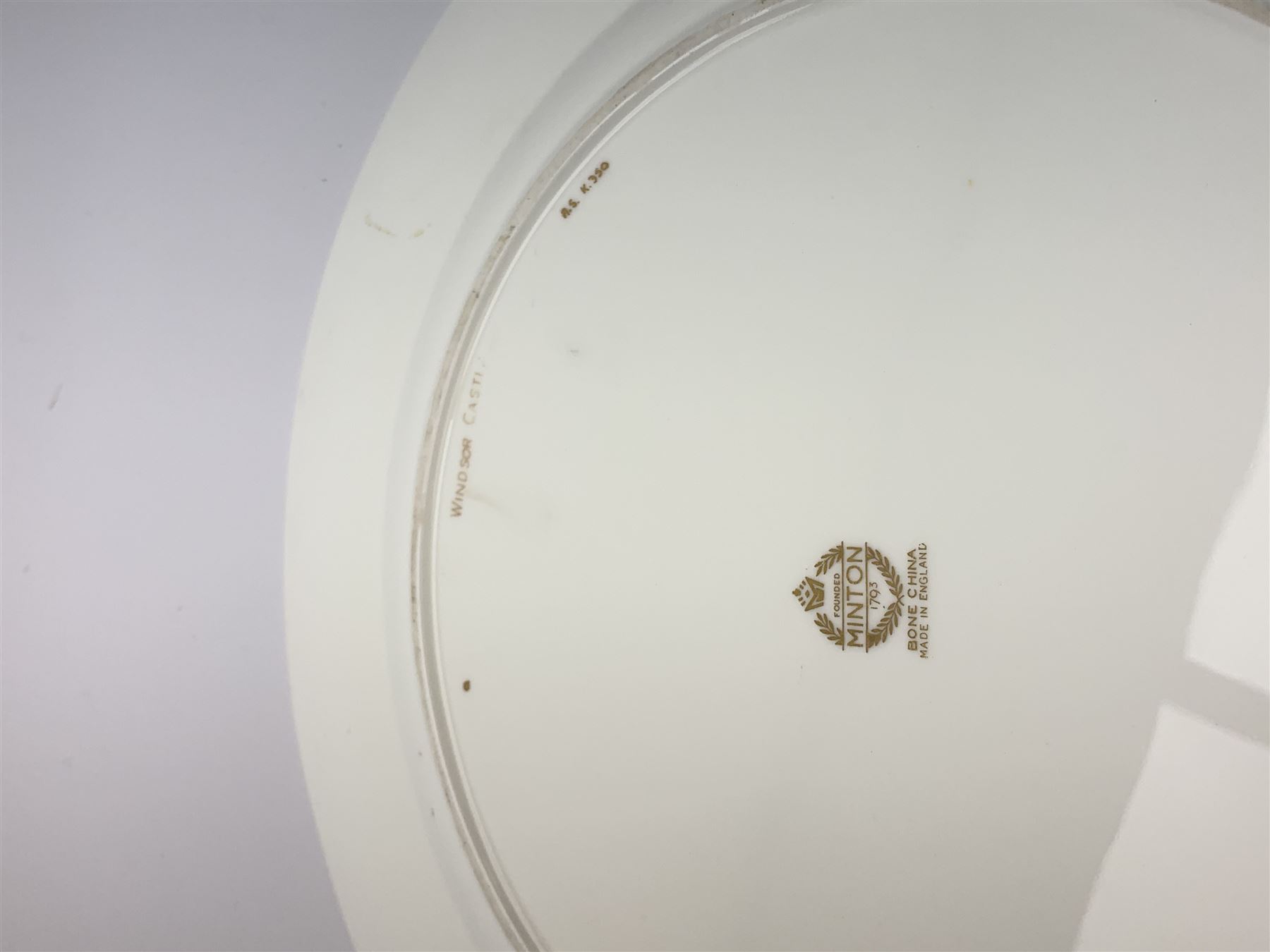 Large Minton cabinet plate, with central hand painted panel of Windsor Castle, signed A Holland, within a tooled gilt turquoise border, with impressed and printed marks and inscribed Windsor Castle beneath, D32cm