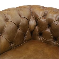 Timothy Oulton for HALO - Two seater brown leather chesterfield sofa, with button back and arms, with two loose cushions, raised on a dark stained supports terminating in castors 