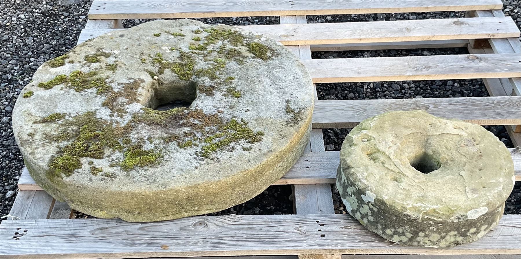 Two 19th century stone mill wheels D64cm and D33cm - THIS LOT IS TO BE COLLECTED BY APPOINTMENT FROM DUGGLEBY STORAGE, GREAT HILL, EASTFIELD, SCARBOROUGH, YO11 3TX