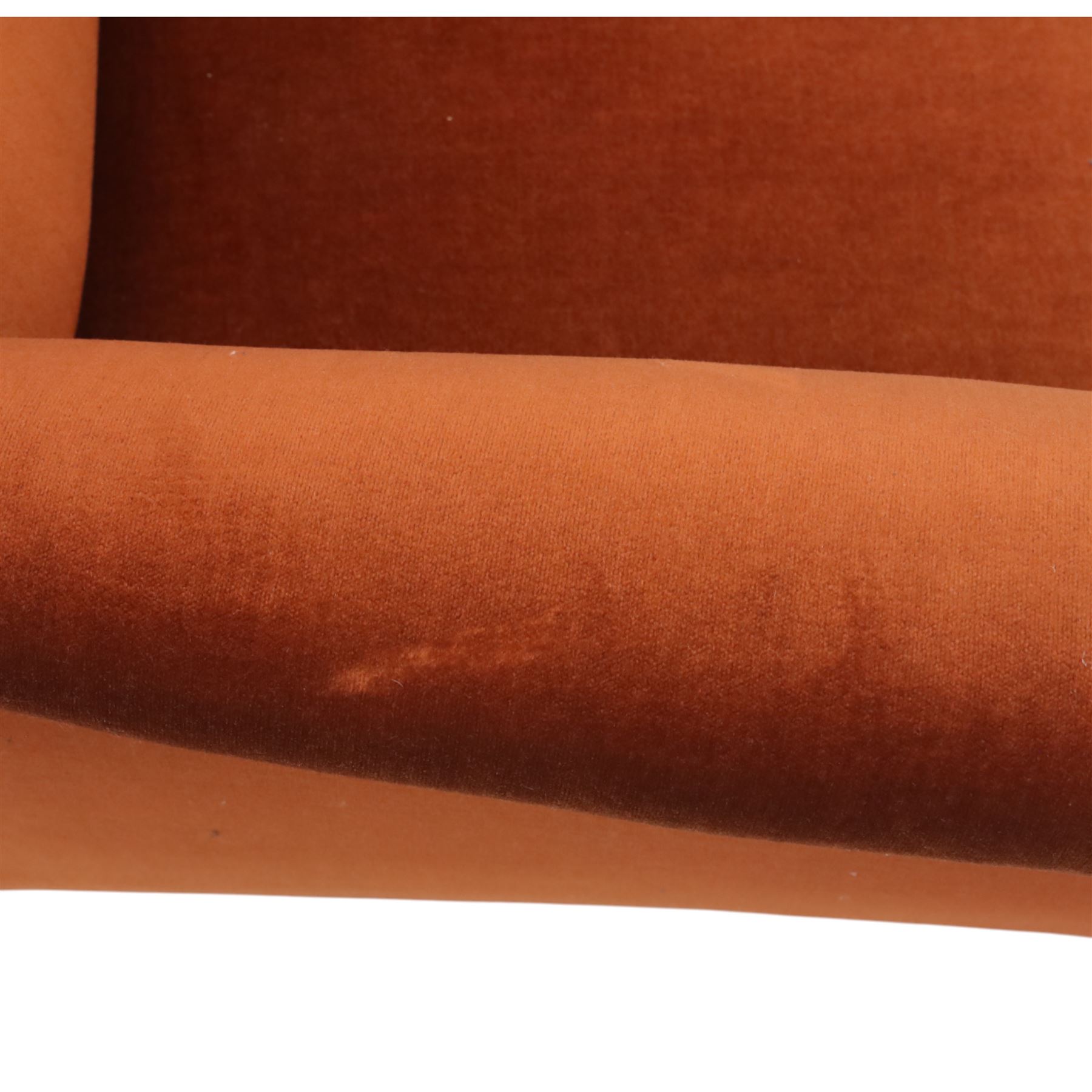 Late 19th century mahogany framed armchair, of generous proportion, upholstered in rust coloured velvet, with shaped back and scroll arms, raised on turned front legs with brass castors