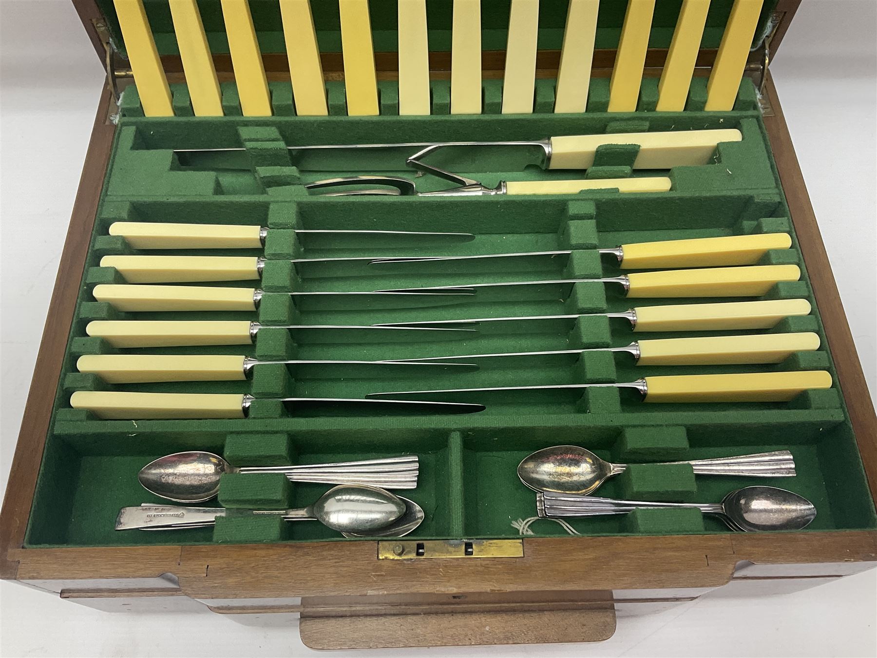 Art Deco canteen of silver plated cutlery for twelve place settings, including table and dessert knives with ivorine handles, retailed by Harrods Ltd, contained within a wooden case, with drawer to base, canteen case H15.5cm