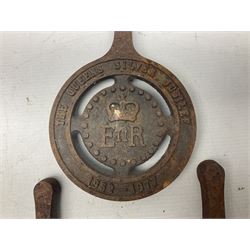 Seven late 20th century cast iron trivets, to include two Queen Elizabeth Silver Jubilee examples, L21cm